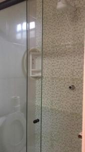 a shower with a glass door in a bathroom at Pousada da Barra - Maraú Bahia in Barra Grande