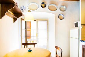a kitchen with a table and plates on the wall at Miralago Apartments Villa Trotti in Bellagio
