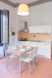 a kitchen with a table with chairs and a sink at Villa il Leone in Florence