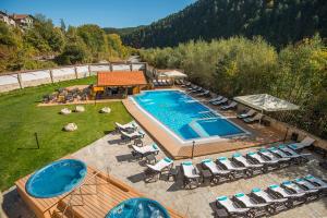 an aerial view of a swimming pool with lounge chairs and a swimming pool at Balneo Complex Saint Spas in Velingrad