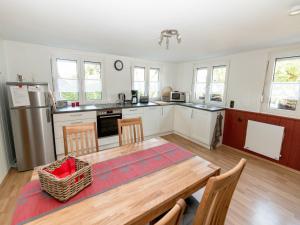 a kitchen with a wooden table and a dining room at Landhof Zitzler in Opfenbach
