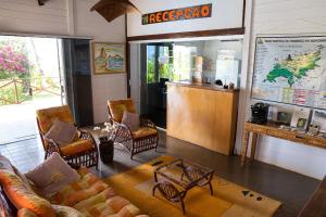 a coffee shop with chairs and a table and a counter at Pousada Sueste in Fernando de Noronha