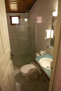 a bathroom with a shower and a toilet and a sink at Pousada Sueste in Fernando de Noronha