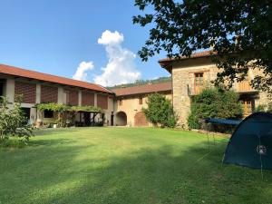 a tent in the grass in front of a building at B&B Barbaia in Levice