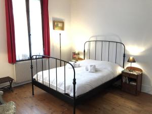 a bedroom with a bed with white sheets and two windows at Angel Services - Le Nant in Saint-Jorioz
