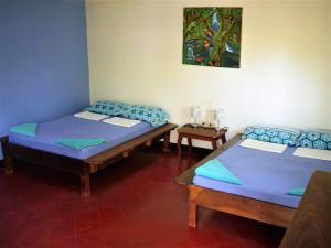 Kama o mga kama sa kuwarto sa Hospedaje Soma Ometepe Hotel
