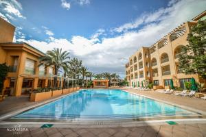 a large swimming pool in the middle of a building at Alhambra Thalasso in Hammamet