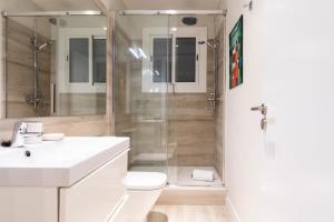 a bathroom with a shower and a sink and a toilet at Aspasios Gracia Apartments in Barcelona +29 photos