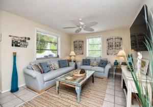 a living room with a couch and a table at Bianco Sands in Siesta Key
