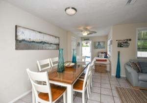 a dining room with a table and chairs at Bianco Sands in Siesta Key