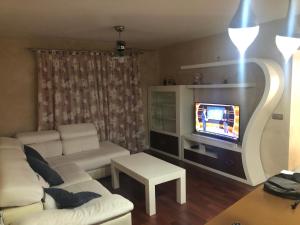 salon z białą kanapą i telewizorem w obiekcie Villa Campito w mieście El Puerto de Santa María