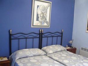 A bed or beds in a room at Casa Rural Torre De Campos