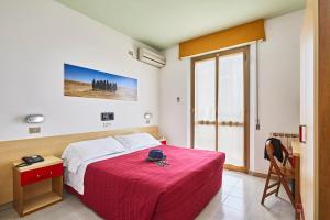 a bedroom with a large bed with a red blanket at Santa Caterina Hotel & Bike in Chianciano Terme +77 photos