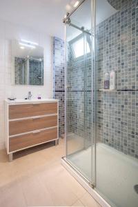 a bathroom with a glass shower and a sink at Habana Apartment in Valencia