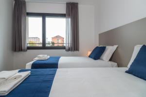 Llit o llits en una habitació de Hotel Cascina Fossata & Residence
