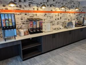 a kitchen with a counter with a coffee shop at La Quinta by Wyndham Montgomery in Montgomery