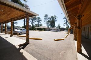 a parking lot with wooden posts and a building at PAYSON INN & Suites in Payson