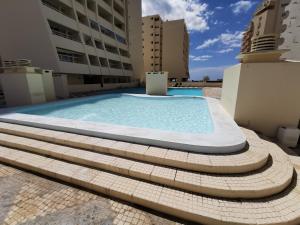 a swimming pool on the roof of a building at Apartment Rocha Varandas Orquídea in Portimão