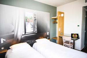 Postel nebo postele na pokoji v ubytování B&B HOTEL Valence TGV Romans