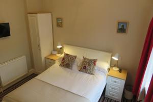 a bedroom with a bed and a lamp at West End Guest House in Elgin