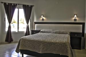 a bedroom with a bed and a large window at Casa Decla in Villa Carlos Paz