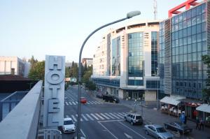 a view of a city street with a hotel sign at Hotel 201 in Podgorica