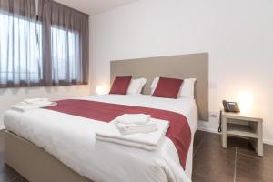 Voodi või voodid majutusasutuse Hotel Cascina Fossata & Residence toas