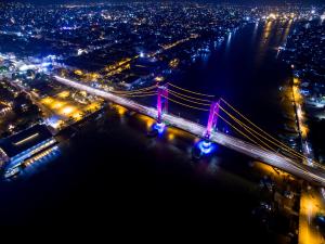 an aerial view of a bridge at night at Monoloog Hotel Palembang in Palembang