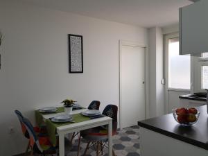 a kitchen with a table and chairs in a room at Apartman Anja in Karlovac