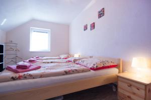 Postel nebo postele na pokoji v ubytování Penzion a vinařství Lelíkovi