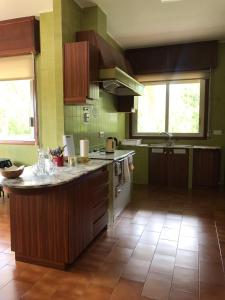 a kitchen with a stove top oven and a sink at Albergue Pallanes in Tui