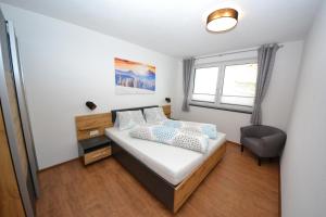 מיטה או מיטות בחדר ב-Alpenapart Gastl
