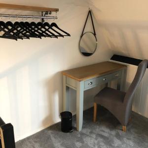 a desk in a room with a chair and a mirror at The Little Angel in Whitby