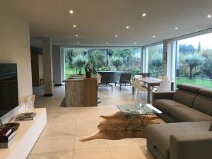 a living room with a couch and a table at Penthouse & Garden - luxury apartment in Postal