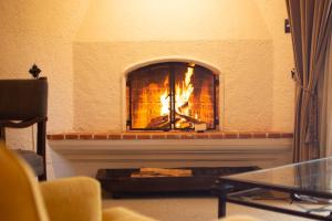a fire in a fireplace in a living room at Hotel Museo Spa Casa Santo Domingo in Antigua Guatemala