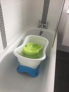 a toilet in a bath tub in a bathroom at 2 bedroom house Belfast city in Belfast