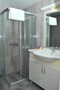a bathroom with a shower and a sink at Lion City Hotel Ankara in Ankara