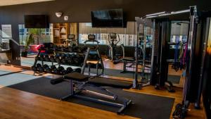 a gym with a lot of treadmills and weights at Hotel Indigo El Paso Downtown, an IHG Hotel in El Paso