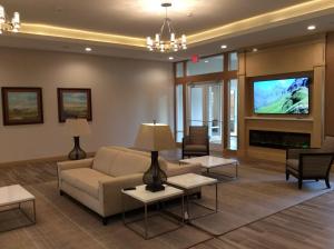 a living room with a couch and a tv at Holiday Inn Trophy Club, an IHG Hotel in Trophy Club