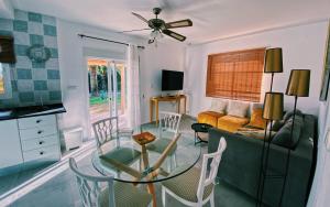 a living room with a glass table and a couch at Villa Tranquilla in Estepona
