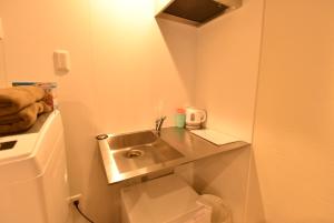 a small bathroom with a sink and a toilet at Enzo Kyoto Gojo E / Vacation STAY 54295 in Kyoto +22 photos