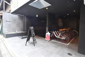 a group of bikes parked in a building with a sign at Enzo Kyoto Gojo E / Vacation STAY 54295 in Kyoto