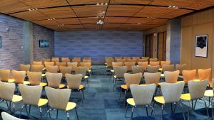 a conference room with rows of chairs and tables at Hotel Indigo El Paso Downtown, an IHG Hotel in El Paso