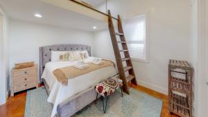 a bedroom with a bunk bed and a ladder at Upstream Bachelorette in Asheville