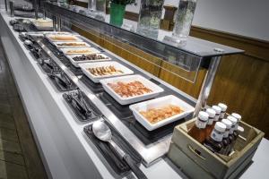 a buffet line with many plates of food at Holiday Inn - Glasgow Airport by IHG in Paisley