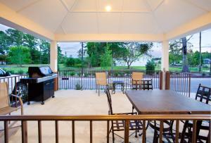 a screened in porch with a table and chairs at Candlewood Suites New Bern by IHG in New Bern