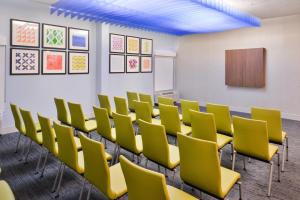 a conference room with yellow chairs and a board at Holiday Inn Express Burlington by IHG in Burlington +63 photos