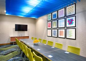 a conference room with a long table and yellow chairs at Holiday Inn Express & Suites - Gainesville I-75 by IHG in Gainesville +48 photos