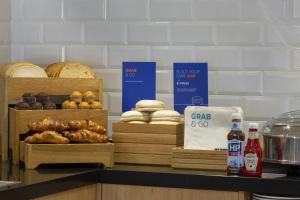 a counter top with a variety of baked goods on it at Holiday Inn Express Edinburgh City Centre, an IHG Hotel in Edinburgh