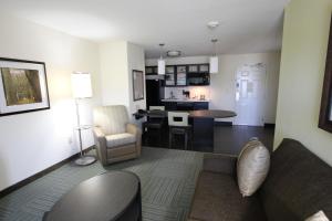 a living room and kitchen with a couch and a table at Candlewood Suites Greenville by IHG in Greenville +34 photos
